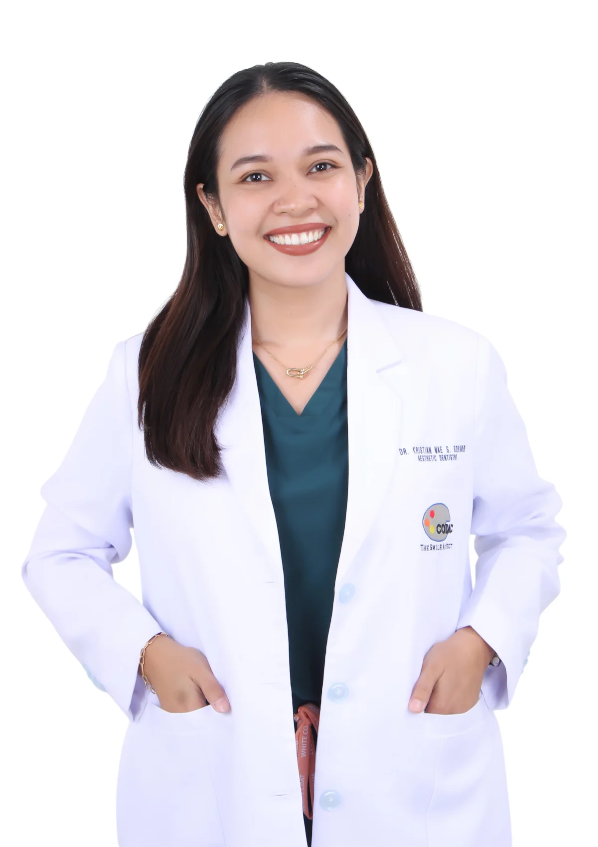 Dr. Kristian Mae S. Soriano smiling in her white dental coat